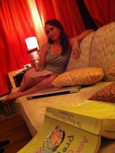 A picture of me from the very start of my pregnancy, guzzling water, a pregnancy book beside me.